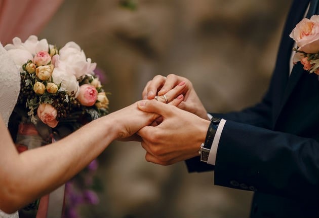 placing wedding band on